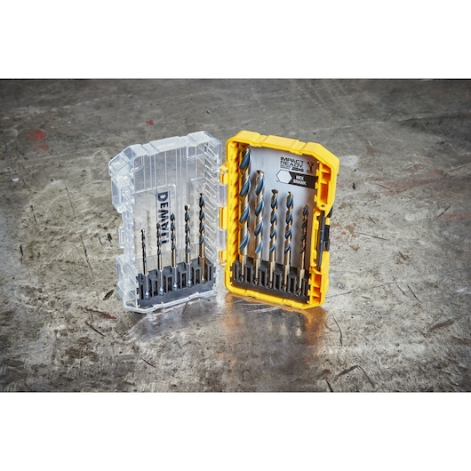 DEWALT DT70702 drill bit set in open yellow case on a metal surface, showing various sizes and hex shank bits.