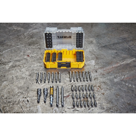 DEWALT DT70702 yellow case with assorted screwdriver bits and accessories organized on a work surface.
