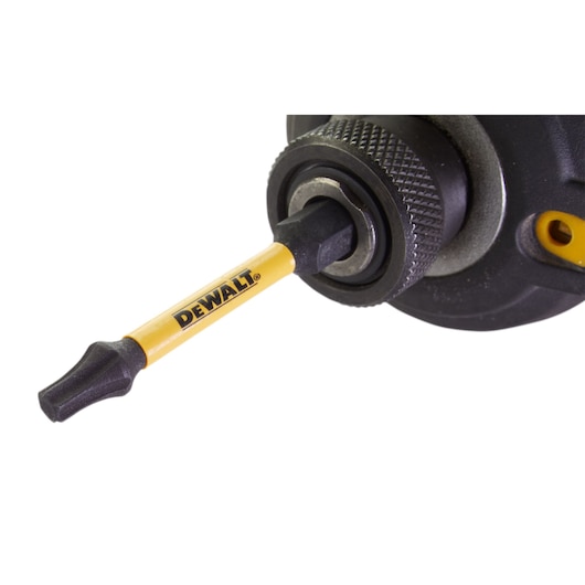 Close-up of a DEWALT screwdriver bit attached to a tool.