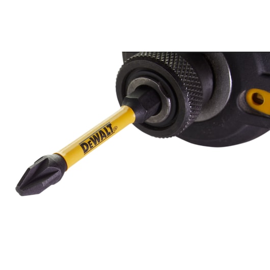 Close-up of a DEWALT screwdriver bit attached to a power tool, with yellow branding visible on the bit.