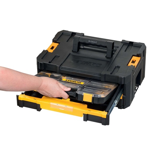 A person is pulling out a clear plastic organizer drawer from a black and yellow DEWALT toolbox.