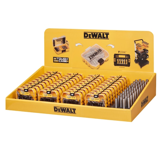 Display box containing multiple DEWALT Tough Case+ sets, each with yellow and black cases and drill bits. The background shows images of a single case, drill bits, and a TSTAK storage system, all in DEWALT branding.