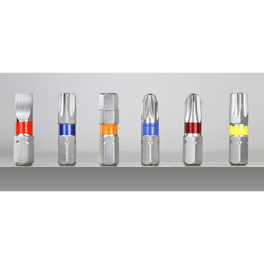 Six DEWALT screwdriver bits with colored bands are arranged side by side on a gray surface.