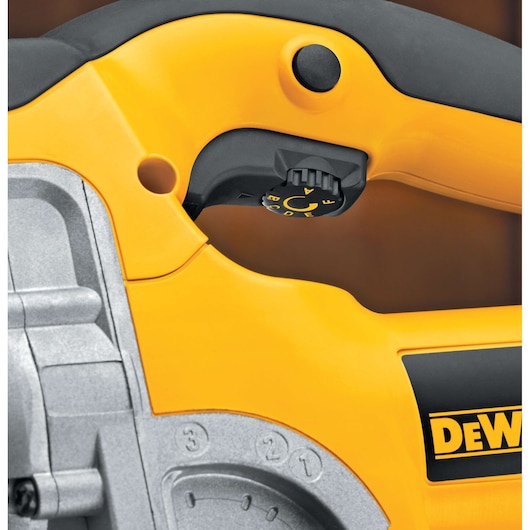 Close-up of a yellow and black DEWALT power tool showing a control dial and part of the handle, with visible adjustment markings.