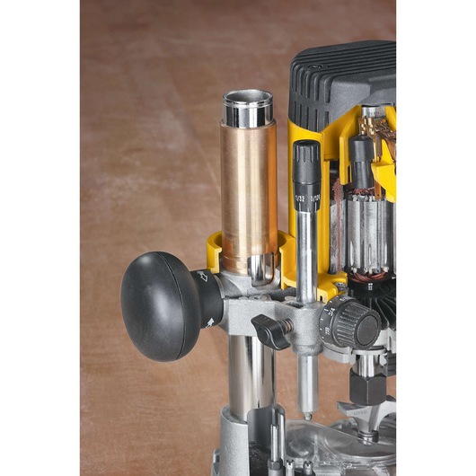 Close-up view of a DEWALT DW621 router, showing its adjustment knob, guides, and part of the motor assembly, designed for precision woodworking tasks.