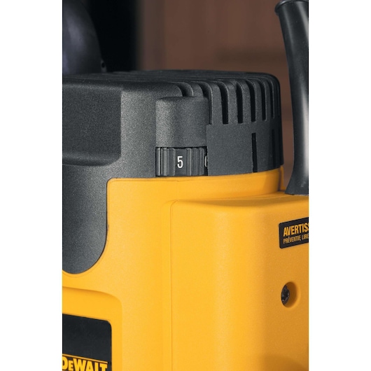 Close-up of a DEWALT DW621 power tool showing a numbered dial on its yellow and black casing.