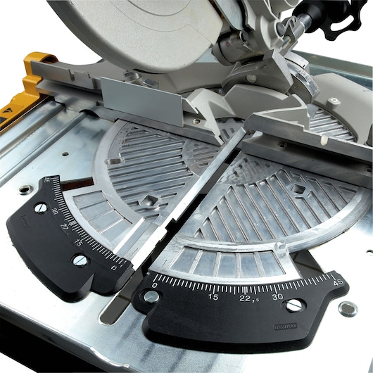 Close-up of DEWALT DW743N mitre saw showing angle measurement scale and cutting guide.