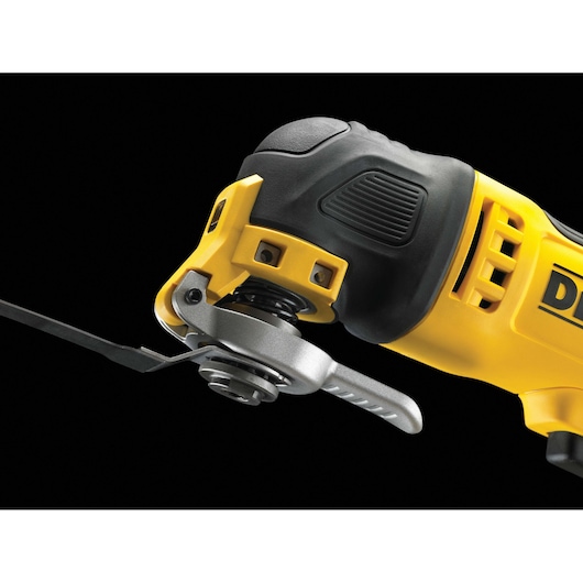 Close-up view of a DEWALT oscillating multi-tool in yellow and black, showing the attachment head and blade.