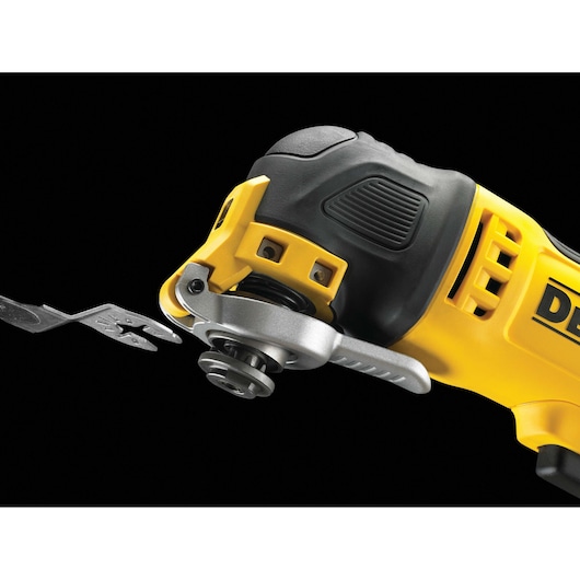 Close-up of a DEWALT oscillating multi-tool with a metal attachment against a black background.