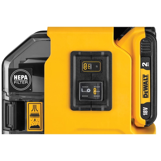 Close-up of DEWALT tool with HEPA filter, control buttons, and 18V 2Ah battery pack visible.