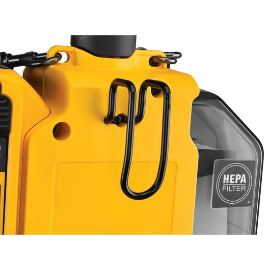 Close-up of a yellow DEWALT device with a HEPA filter and metal clip on the side.