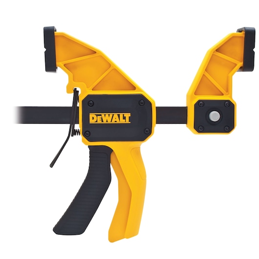 DEWALT yellow and black trigger clamp for securing materials during photography or construction tasks.
