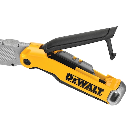 Close-up of a DEWALT yellow folding utility knife with blade storage compartment open.