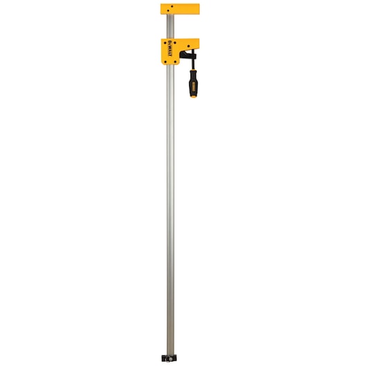 DEWALT bar clamp with yellow jaws and long metal shaft, designed for woodworking and secure holding tasks.