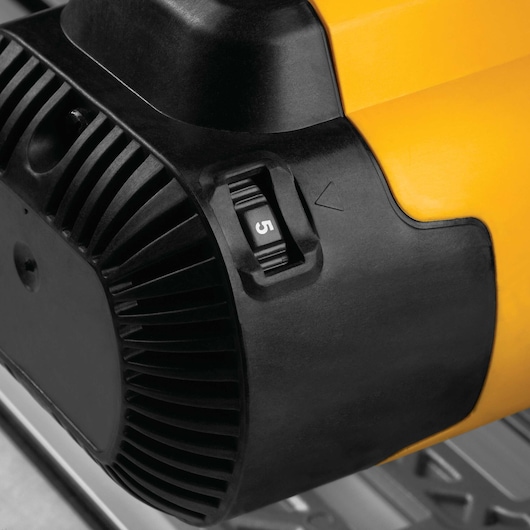 Close-up of a DEWALT power tool showing the black and yellow casing with a numbered dial set to 5.