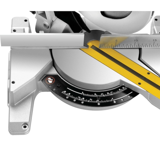 Close-up of DEWALT DWS778 mitre saw with angle scale, ruler, and cutting guide in silver and yellow.