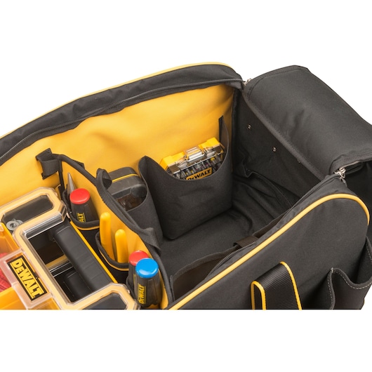 DEWALT tool bag with organized compartments, storing drills, accessories, and screw boxes in a padded interior.