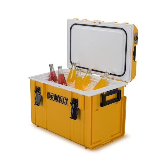 A yellow DEWALT cooler box with an open lid, containing ice and several glass bottles of orange and red beverages.