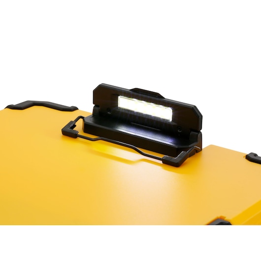Close-up of a yellow DEWALT tool storage box featuring an integrated LED light on the lid.