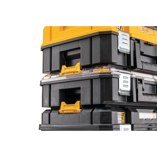 Close-up view of stacked DEWALT black and yellow tool storage boxes with metal latches and handles.