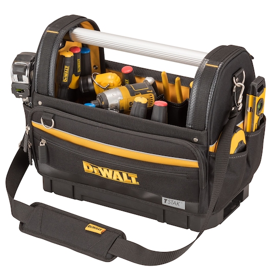 A black and yellow DEWALT tool bag with a metal handle, filled with various hand tools and power tools, including drill, screwdrivers, tape measure, and other accessories. The bag has multiple compartments and pockets, and features a shoulder strap for easy carrying.