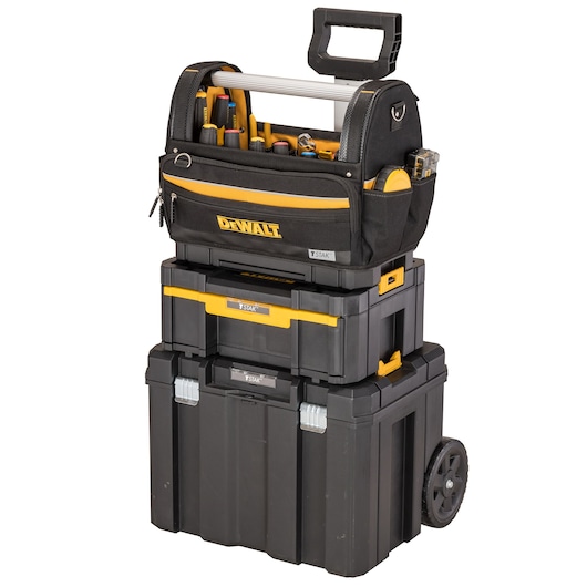 A DEWALT mobile tool storage system consisting of three stackable black toolboxes and a black fabric tool bag with multiple hand tools, all branded with the DEWALT logo. The system includes a wheeled base for easy transport.