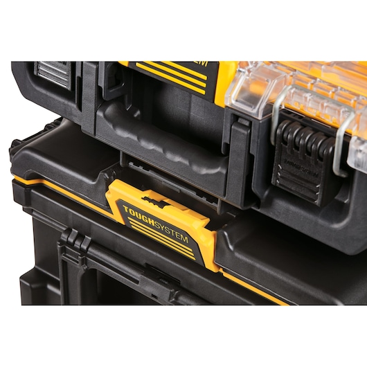 Close-up of DEWALT ToughSystem black and yellow toolboxes stacked and showing handle and latch details.