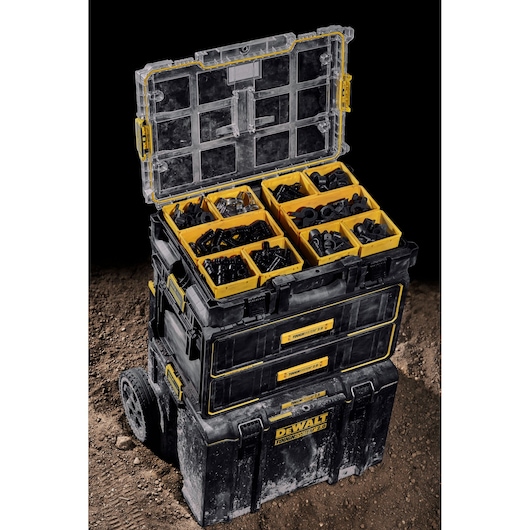 DEWALT Toughsystem stackable storage boxes with open top box showing yellow compartments for tool accessories.