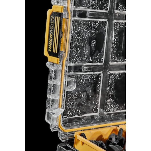 Close-up of a wet DEWALT ToughSystem photography case with a clear lid and yellow lock.