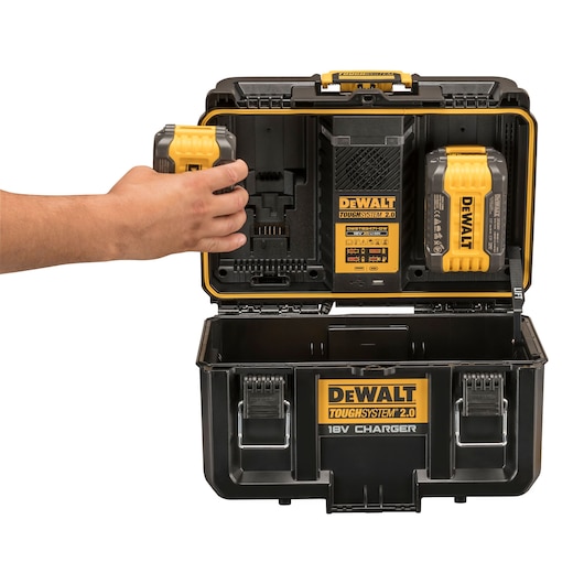 DEWALT Toughsystem 2.0 charger box open with a hand inserting a battery, showing compartments and charger.