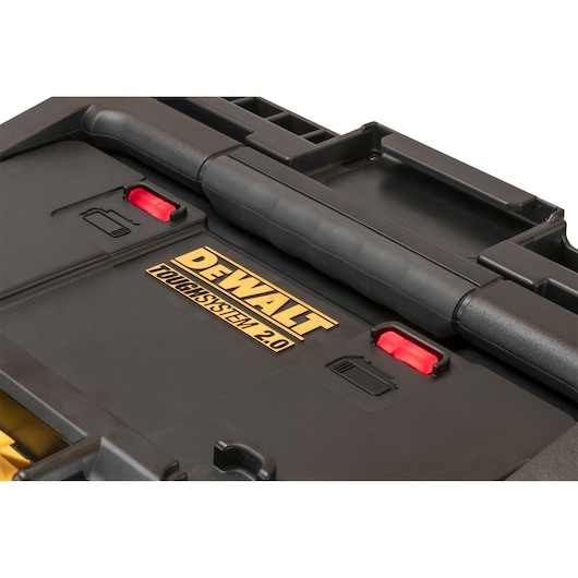 Close-up of DEWALT ToughSystem 2.0 toolbox lid, showing handle and two red latches.