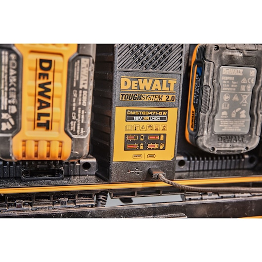 Close-up of DEWALT Toughsystem 2.0 DWST83471 charging station with batteries and USB port.