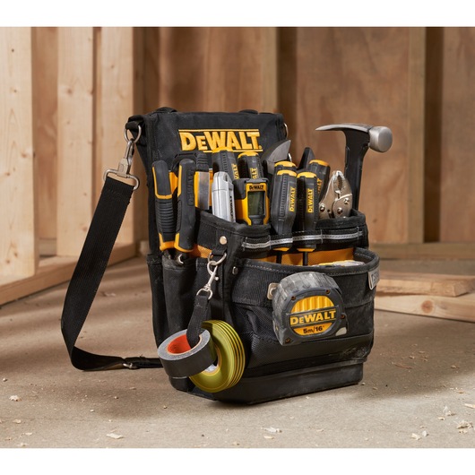 A DEWALT tool bag filled with various hand tools, including screwdrivers, pliers, a hammer, utility knives, measuring tape