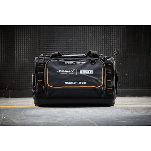 Special edition DEWALT ToughSystem 2.0 tool bag with McLaren branding, black, shown on industrial floor.