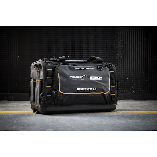 DEWALT ToughSystem 2.0 special edition tool bag, black with orange accents, displayed on a concrete floor.