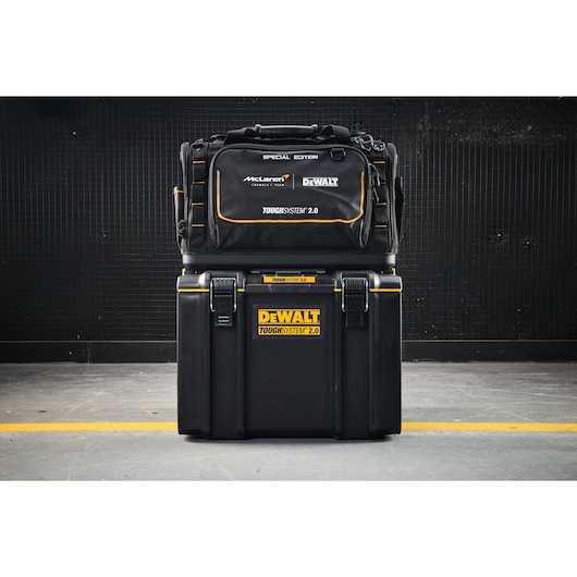 DEWALT ToughSystem 2.0 tool bag and storage box stacked together in an industrial setting.